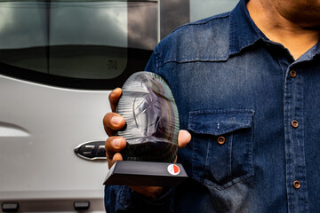 Tourist guide showing an obsidian handcraft to a group of visitors at the Teotihuacan archeological site.