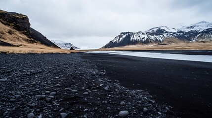 Breathtaking landscape of a black sand beach framed by majestic snow capped mountains under a cloudy sky : Generative AI