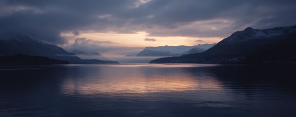 Fototapeta premium Peaceful twilight over serene lake with majestic mountains and mystical clouds