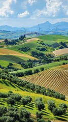 Fototapeta premium Rolling hills, vineyards, olive groves, and wind turbines under a partly cloudy sky.