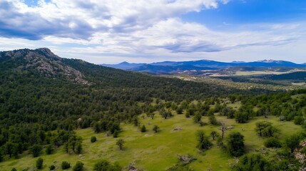 Naklejka premium Breathtaking aerial view of lush green hills and mountains under a vast blue sky : Generative AI