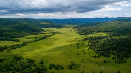 Obraz premium Stunning Aerial Landscape of Lush Green Hills Under a Dramatic Sky : Generative AI