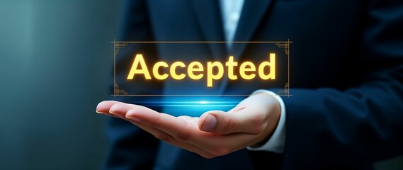 Hand displaying accepted notification in a professional setting with warm lighting