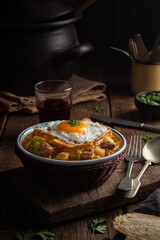 Charquicán with egg on top, traditional Chilean dish with potatoes, pumpkin, corn and ground beef.