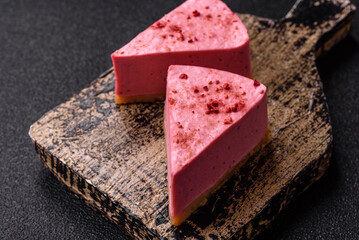 A piece of sweet cheesecake with raspberry or strawberry flavor