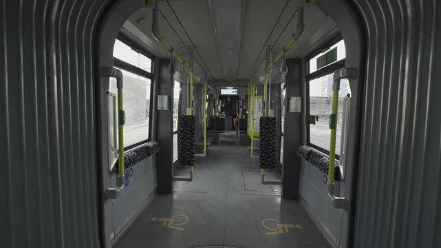 Berlin streetcar interior during the ride. Theme electric rail public transportation in Berlin, Germany. Interior view of Berlin streetcar, empty compartment. Strassenbahn in Berlin Innenaufnahme. 