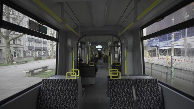 Berlin streetcar interior during the ride. Theme electric rail public transportation in Berlin, Germany. Interior view of Berlin streetcar, empty compartment. Strassenbahn in Berlin Innenaufnahme. 