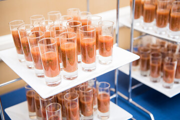 Tray of brown shooter drinks.