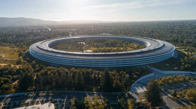 High-angle view of Apple Park, Cupertino, CA. Iconic spaceship-shaped building, surrounded by lush greenery. Modern architecture and natural beauty. California, USA. 18 June 2024