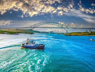 A tug boat guides a cruise hip to the Pacific Ocean after crossing the Panama Canal and navigating...