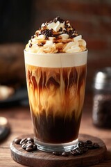 Iced drink with whipped cream, a classic choice for dessert or breakfast. Topped with foamy latte art.
