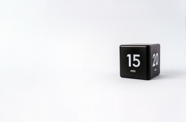 Black cube timer with 15 minutes sign on white background. Minimal interval time concept. Copy space, selective focus