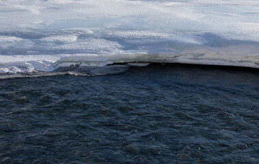River partially frozen, partially flowing in Alaska