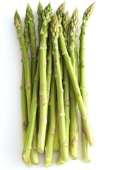 Bunch of green asparagus spears with purple tips on white background.