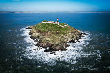 Aerial view of Ballycotton Lighthouse on Ballycotton Island, County Cork, Ireland, a historic black-painted lighthouse overlooking the Atlantic Ocean