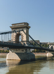 Obraz premium chain bridge over river with beautiful stone made design over danube hungary