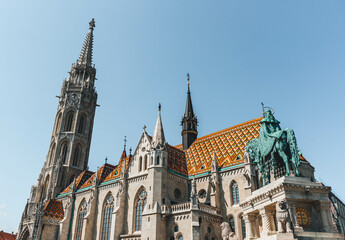Fototapeta premium minimalist view of top of tower cathedral in hungarian architecture style over sunrise light