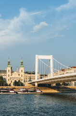 modern bridge over river with beautiful stone made design over danube hungary and parliament behind