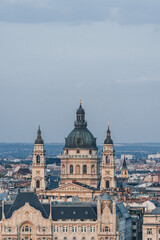 Naklejka premium view of cathedral church hungarian catholic with big bell towers in front and dome over the city skyline