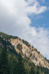 high mountain landscape with rocky peks on cloudy days