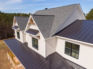 Sunny Daytime Drone Images of a Custom Home in the Final Stages of Construction. It Features a Roof...