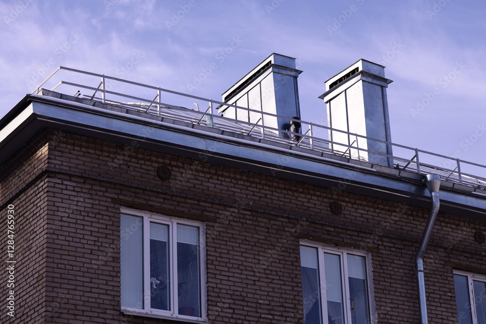 Poster a person standing at the edge of a rooftop with cityscape in the background.
