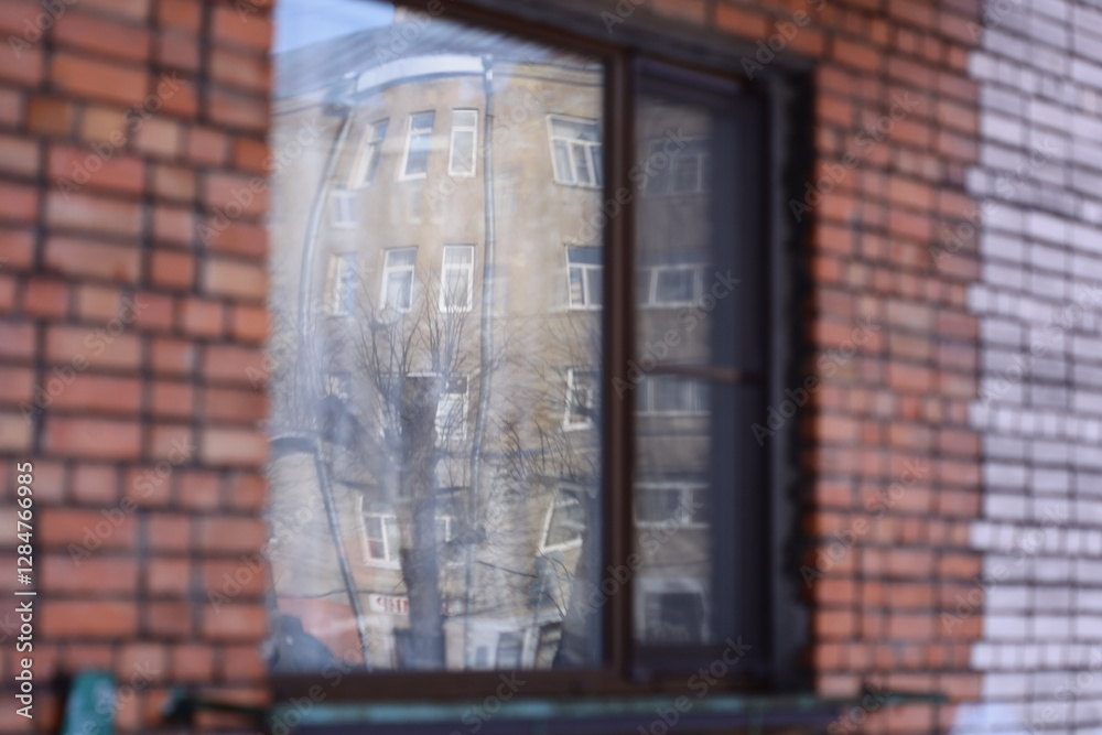Poster A reflection of a building is visible through a window, providing a unique perspective.