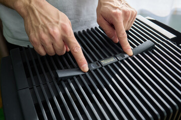 Hands adjusting a modern appliances control panel for optimal functionality and home comfort