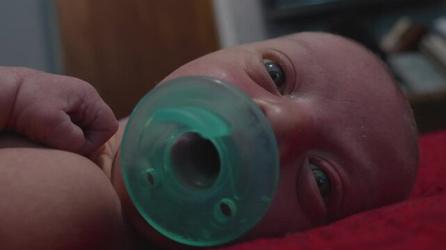 Newborn Baby Sucking on Pacifier
