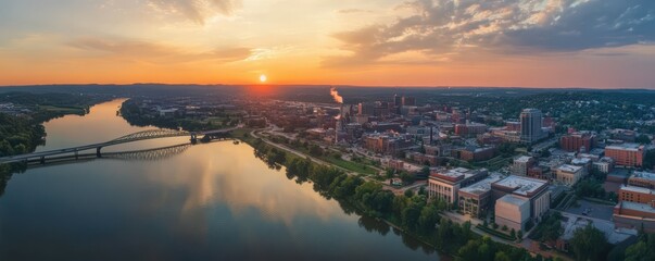 Fototapeta premium Sunset over charleston: aerial view of urban riverfront and bridge