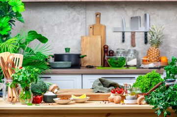 From farm to table: rustic kitchen with organic goodness, food background. Oak cutting board with vegetables, herbs, mushrooms and linen towel on cozy kitchen with wooden table, kitchenware 