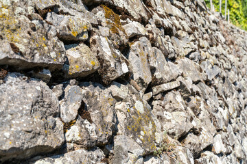 Old dry stone wall with moss and lichen