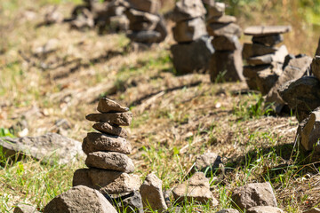 Stone towers piled up by traveling tourists in a natural environment