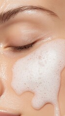 Fototapeta premium Cleansing foam cascading over woman's face, eyes closed, embodying delicate skincare ritual for luminous, healthy complexion