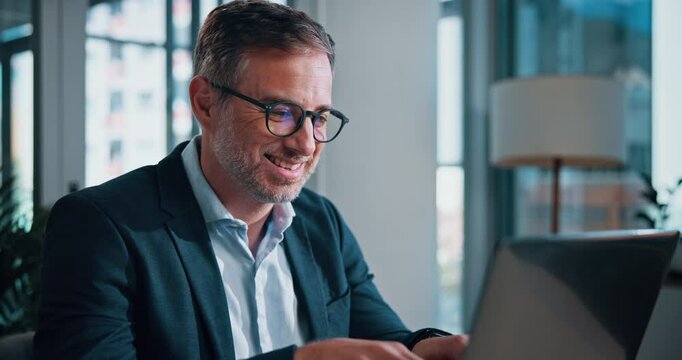 Mature man, smile and laptop in office for report, feedback and typing with at insurance agency. Person, actuary and risk assessment manager with problem solving, statistics and review at company