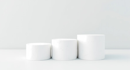 three white cylindrical forms on minimalist display
