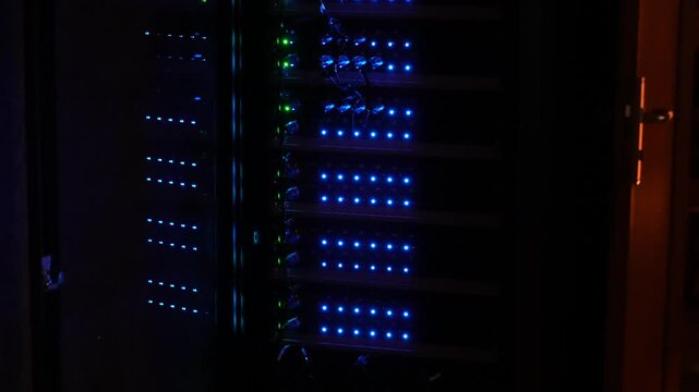 Close-up of flashing LED lights on data center networking equipment, with a stage splitter in working condition ensuring stable connectivity.