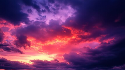Fototapeta premium Dark red and purple sunset clouds glowing in the twilight sky, transitioning into night