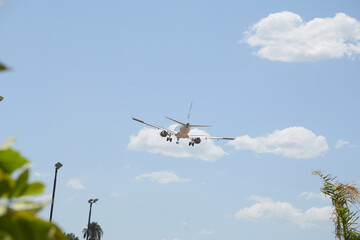 A plane soaring through the sky, symbolizing a journey of hope and new possibilities, with a clear blue backdrop.