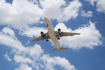 A plane soaring through the sky, symbolizing a journey of hope and new possibilities, with a clear blue backdrop.