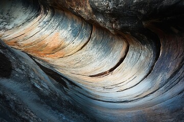 Abstract Stone Texture Background Natural Rock Formation Swirling Curves Elegant Design Detailed Pattern Gray Brown Orange Hues Rock Wall Scenic View 
