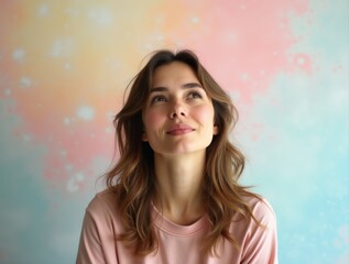 Fototapeta premium Young woman dreaming, looking up on pastel studio background