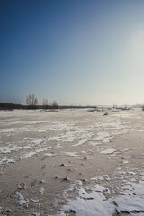 Sand quarry in th Vilnohirsk , Ukraine. Winter landscape on the sand quarry ,sun rays on the sy ,...
