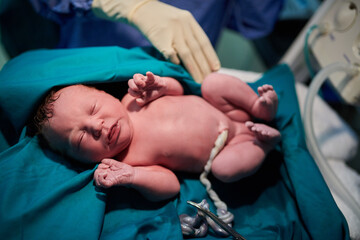 Baby, midwife and newborn with hands at hospital for delivery, check and assessment for wellness....