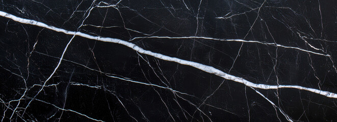 Deep black marble surface with intricate white and gray veining patterns