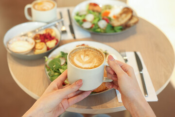 Woman having tasty breakfast in cafe, closeup