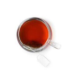 Tea bag in glass cup with hot drink isolated on white, top view