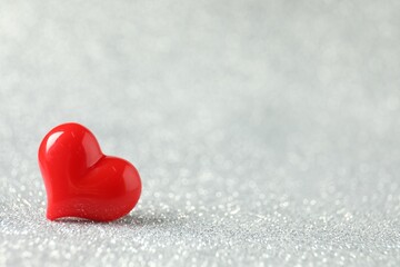 Fototapeta premium Red decorative heart on shiny silver background, space for text. Happy Valentine's day