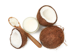 Cooking oil in glass jar, coconuts and spoon isolated on white, top view