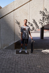 Skateboard, portrait and fitness with man in city for culture, extreme sports and trick flip. Urban, hobby and street league with person training downtown for skating, ollie grind and balance